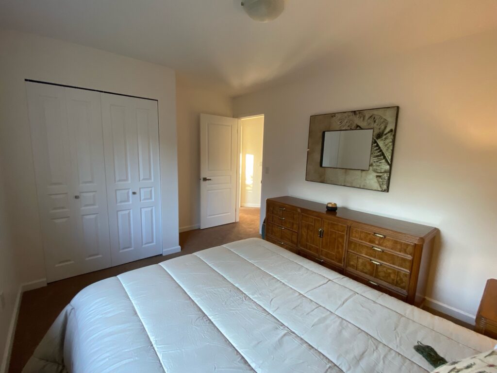 Bedroom 3 showing bed, dresser, mirror and entrance