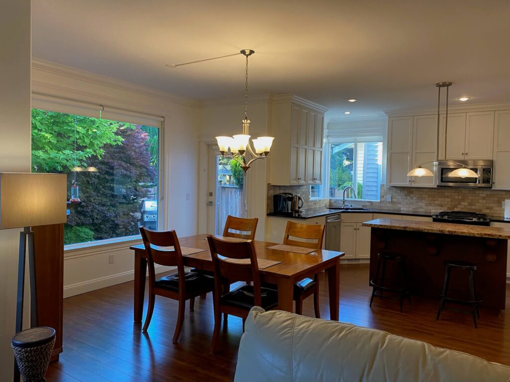 Dining table beside large picture window into back yard