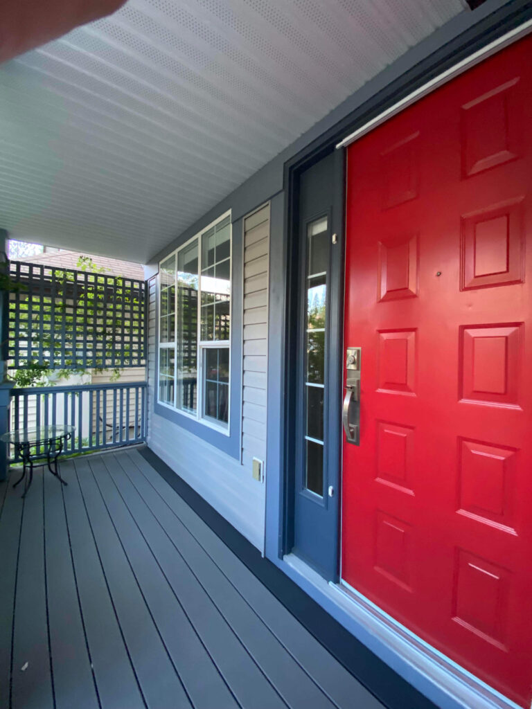 Red door and front entrance deck on single home