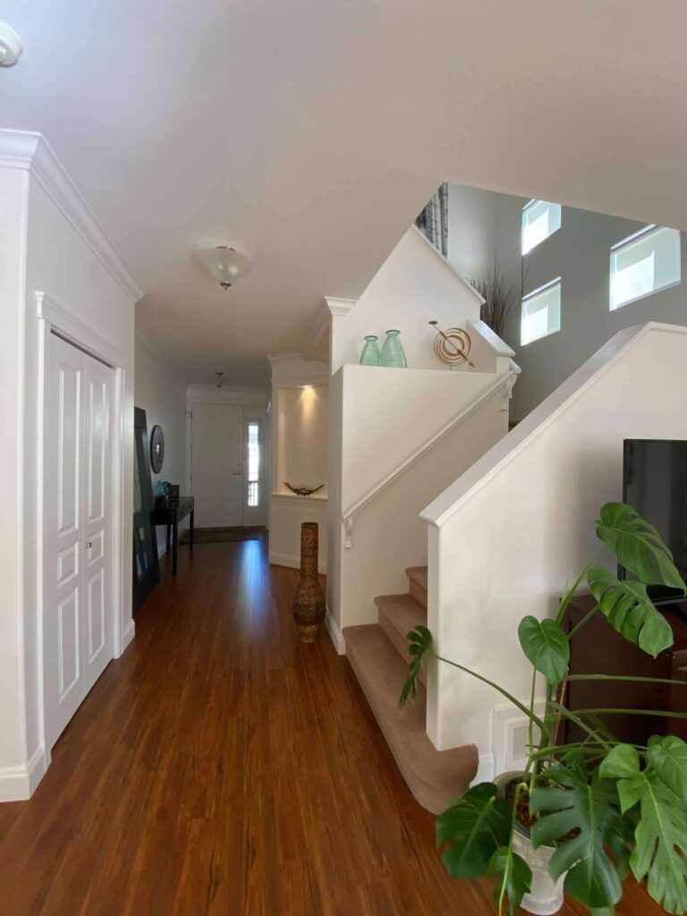 Main hallway to front door showing upper staircase