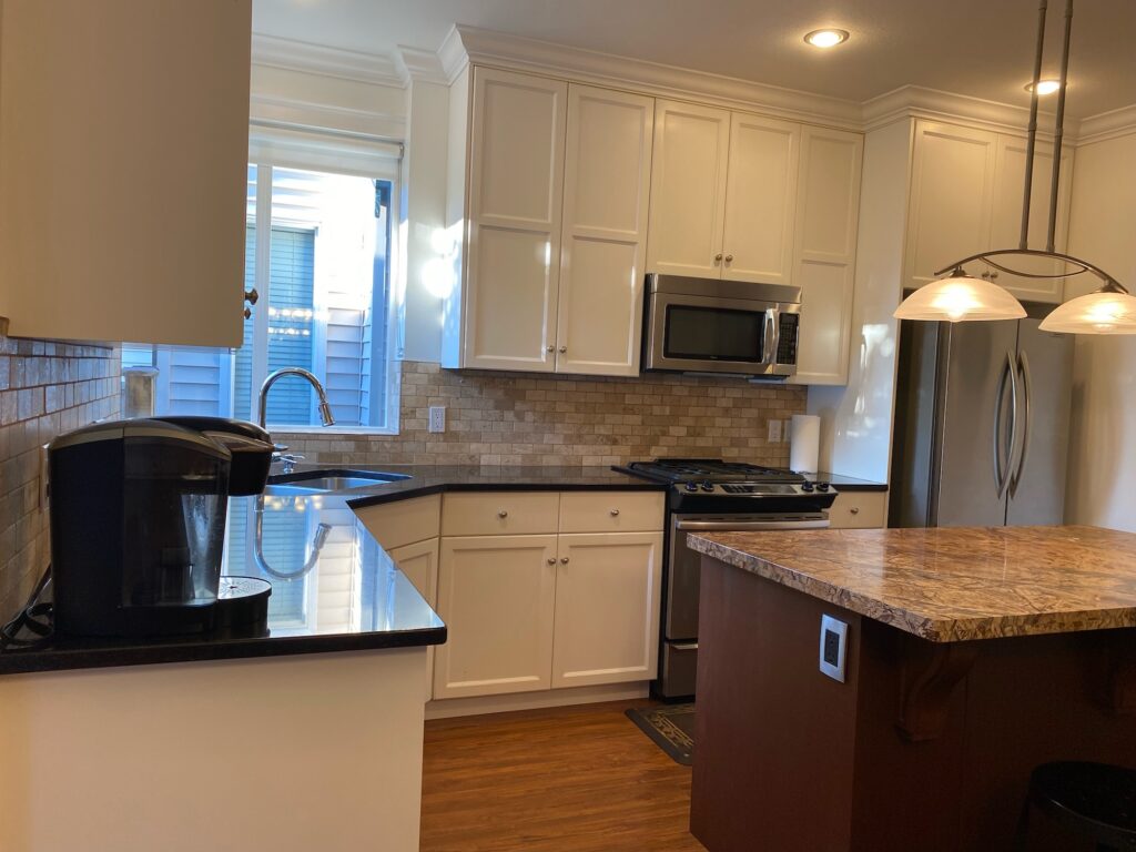 Kitchen facing east showing countertops, cupboards and island