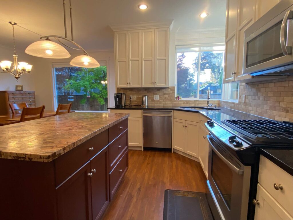 Kitchen East View Showing Counters, Island, Cupboards & Dining Window