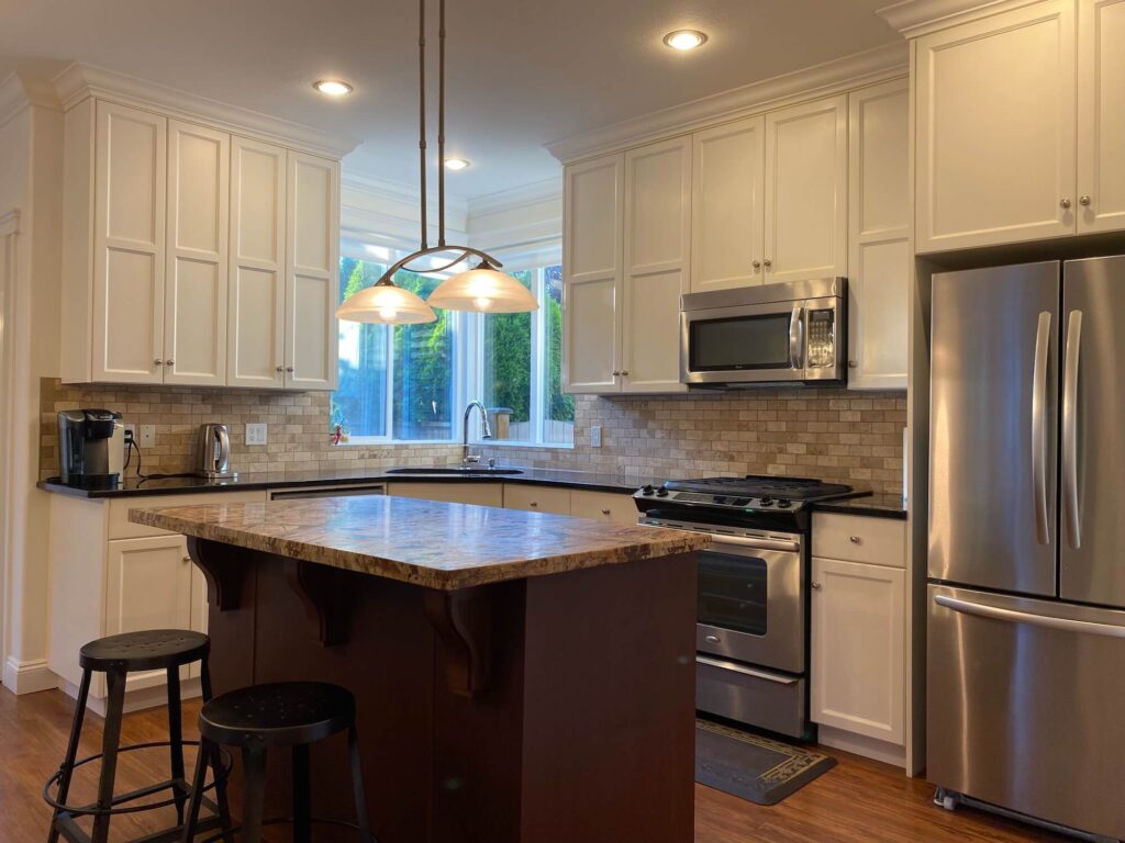 Kitchen showing island and appliances