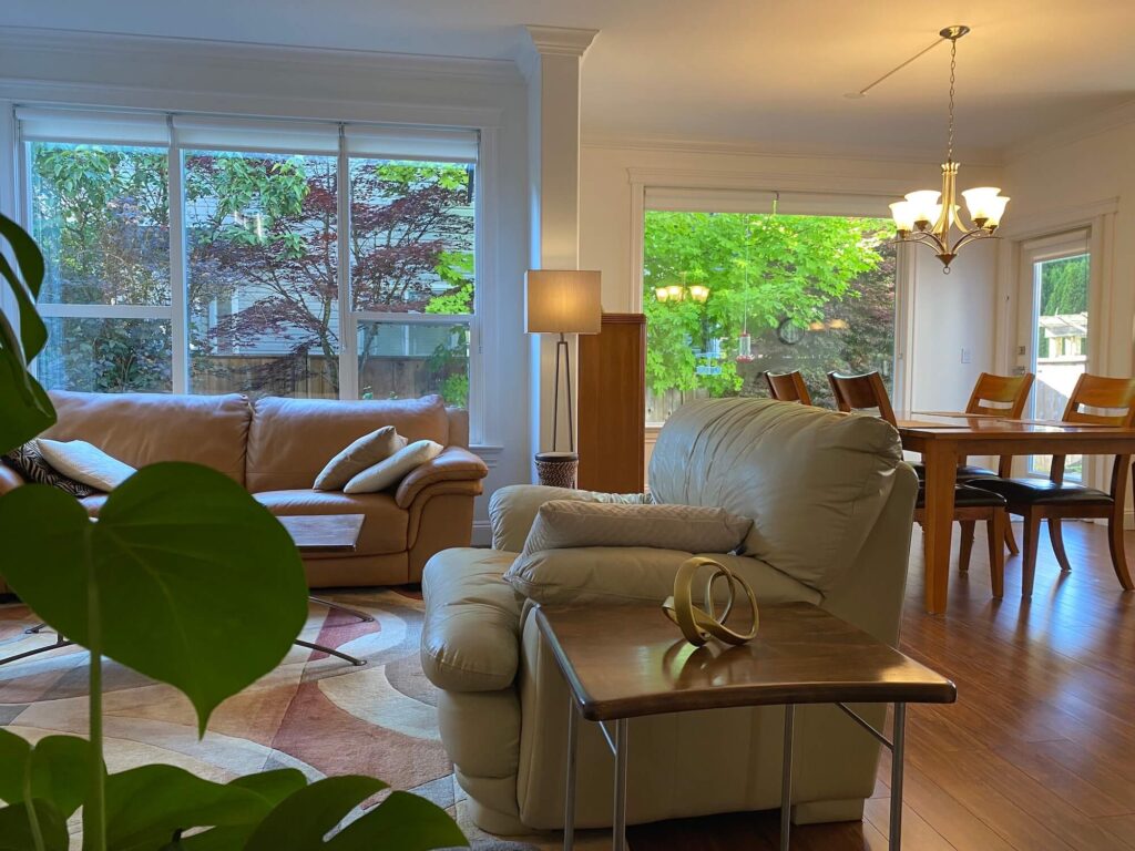 Living room showing sofa, chair and partial dining room