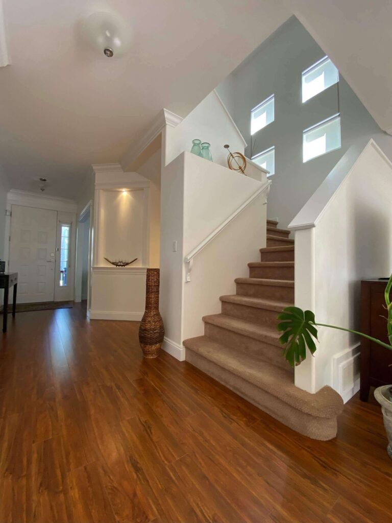 Walnut Grove home main entrance hallway showing upper staircase