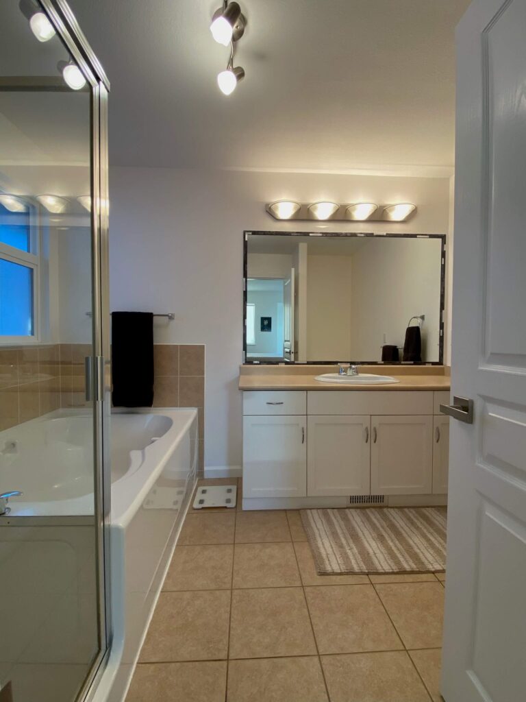 Master bath facing in showing shower, tub and countertop